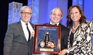 League Director/Eagle & Badge Foundation President Peter Repovich and League President Tyler Izen present the “In the Line of Duty” award to California Attorney General Kamala Harris.